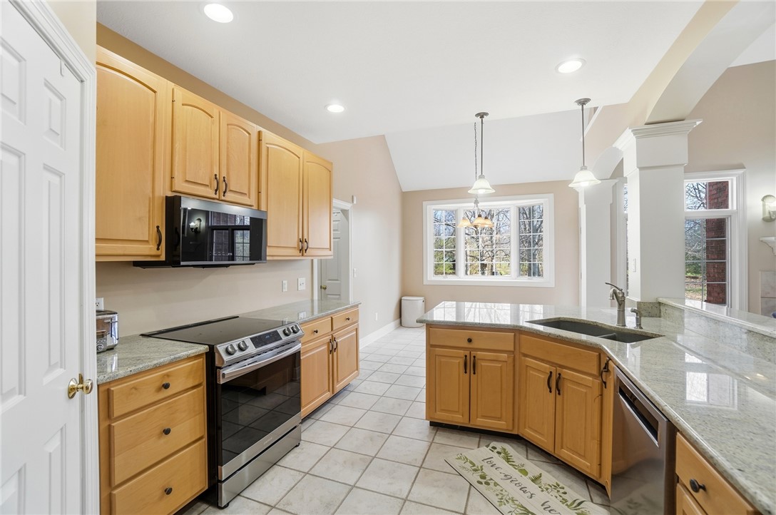 472 Timber Walk Court Springboro, OH 45066 - Photo 13 of 86 Bright and airy kitchen featuring ample cabinetry, sleek countertops, and a charming window view.