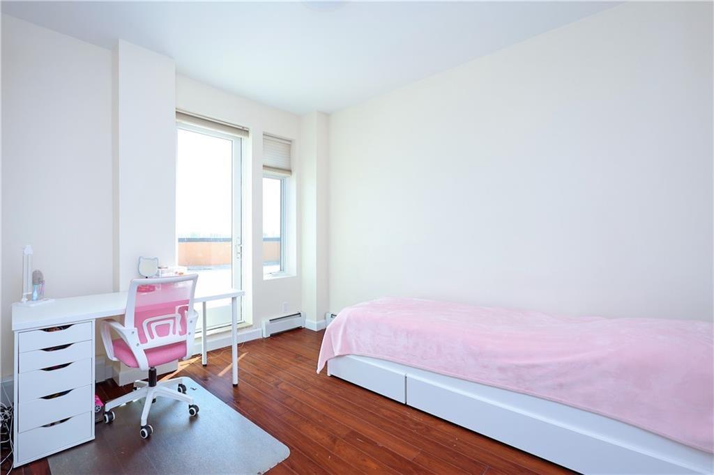 7819 Bay Parkway, Unit PH Brooklyn, NY 11214 - Photo 11 of 28 a bedroom with a bed and a window