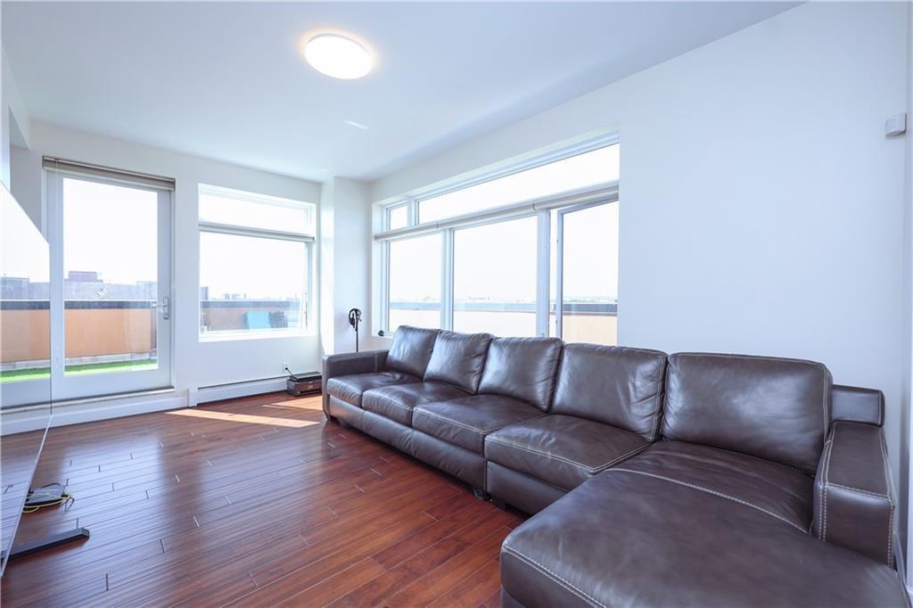 7819 Bay Parkway, Unit PH Brooklyn, NY 11214 - Photo 3 of 28 a living room with a couch and a large window