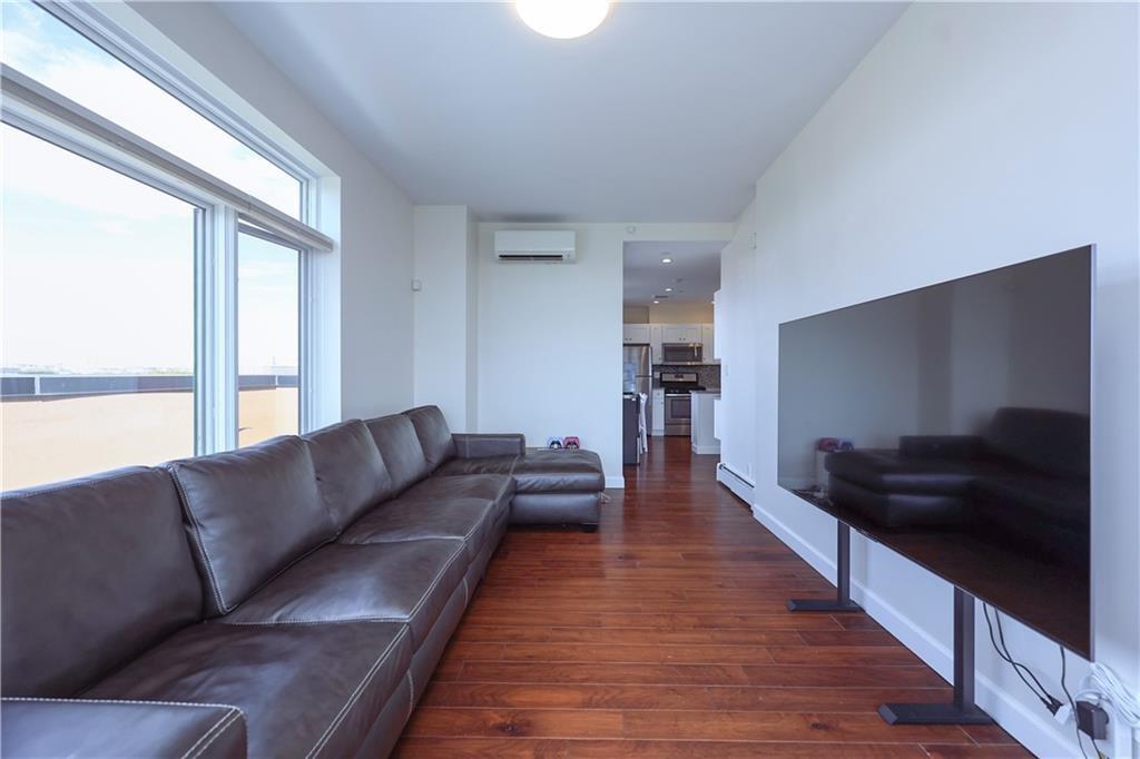 7819 Bay Parkway, Unit PH Brooklyn, NY 11214 - Photo 4 of 28 a living room with furniture and a flat screen tv