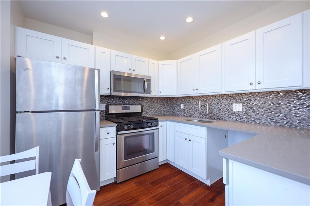 7819 Bay Parkway, Unit PH Brooklyn, NY 11214 - Photo 7 of 28 a kitchen with stainless steel appliances granite countertop a refrigerator sink and microwave