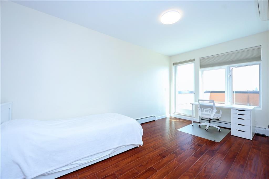 7819 Bay Parkway, Unit PH Brooklyn, NY 11214 - Photo 10 of 28 a room with a bed and a window