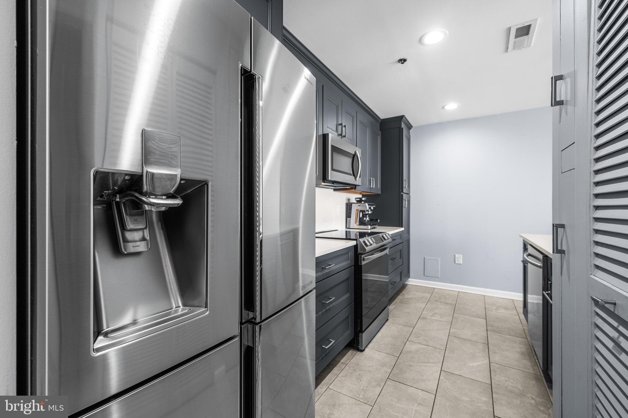 2702 Lighthouse Point East, Unit 720 Baltimore, MD 21224 - Photo 13 of 37 a kitchen with stainless steel appliances granite countertop a refrigerator and a sink
