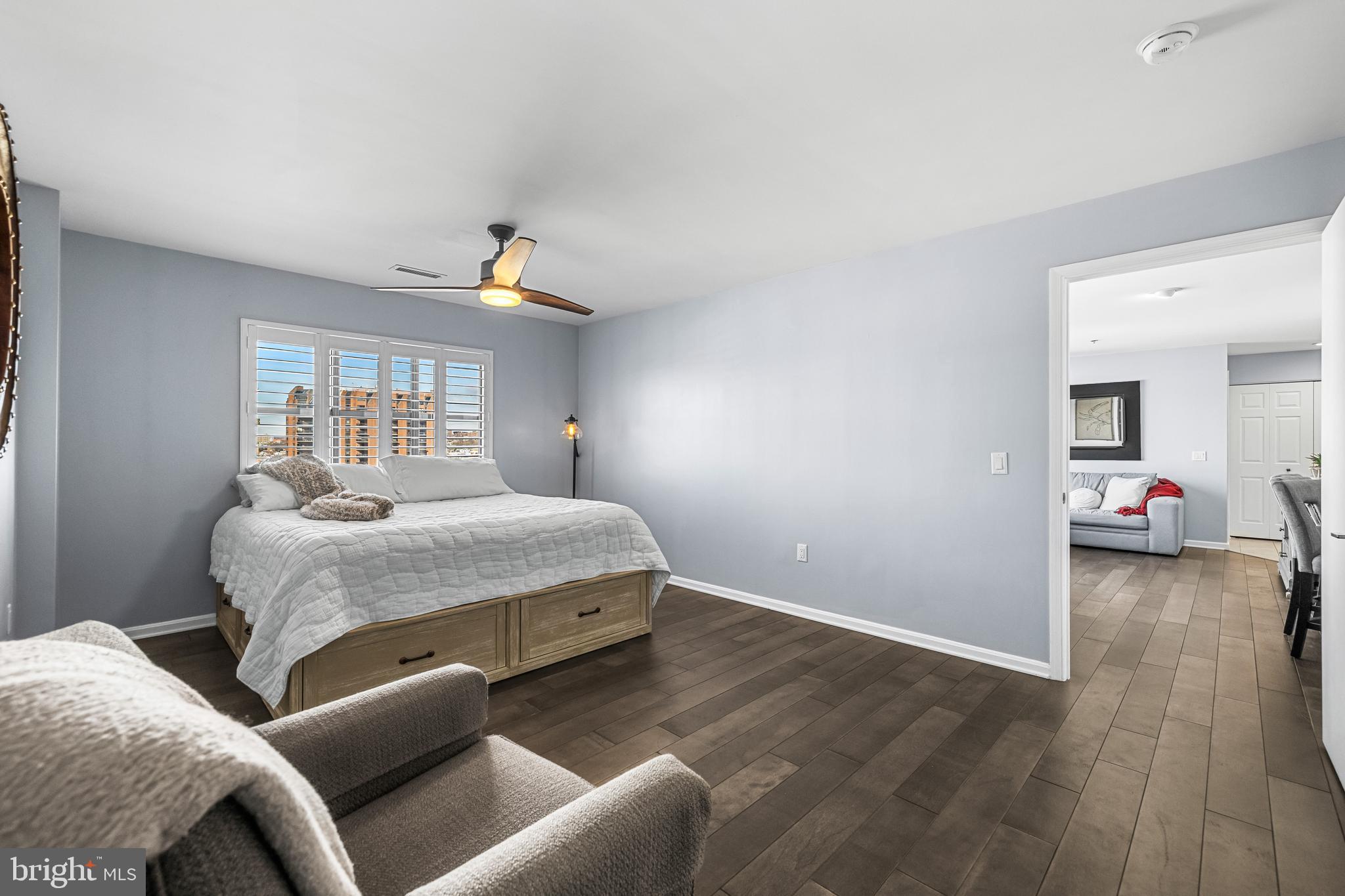 2702 Lighthouse Point East, Unit 720 Baltimore, MD 21224 - Photo 15 of 37 a bedroom with a bed and a chandelier