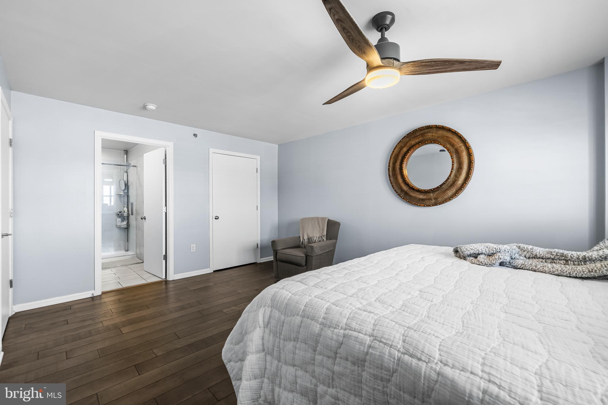 2702 Lighthouse Point East, Unit 720 Baltimore, MD 21224 - Photo 16 of 37 a bedroom with a bed and a chandelier