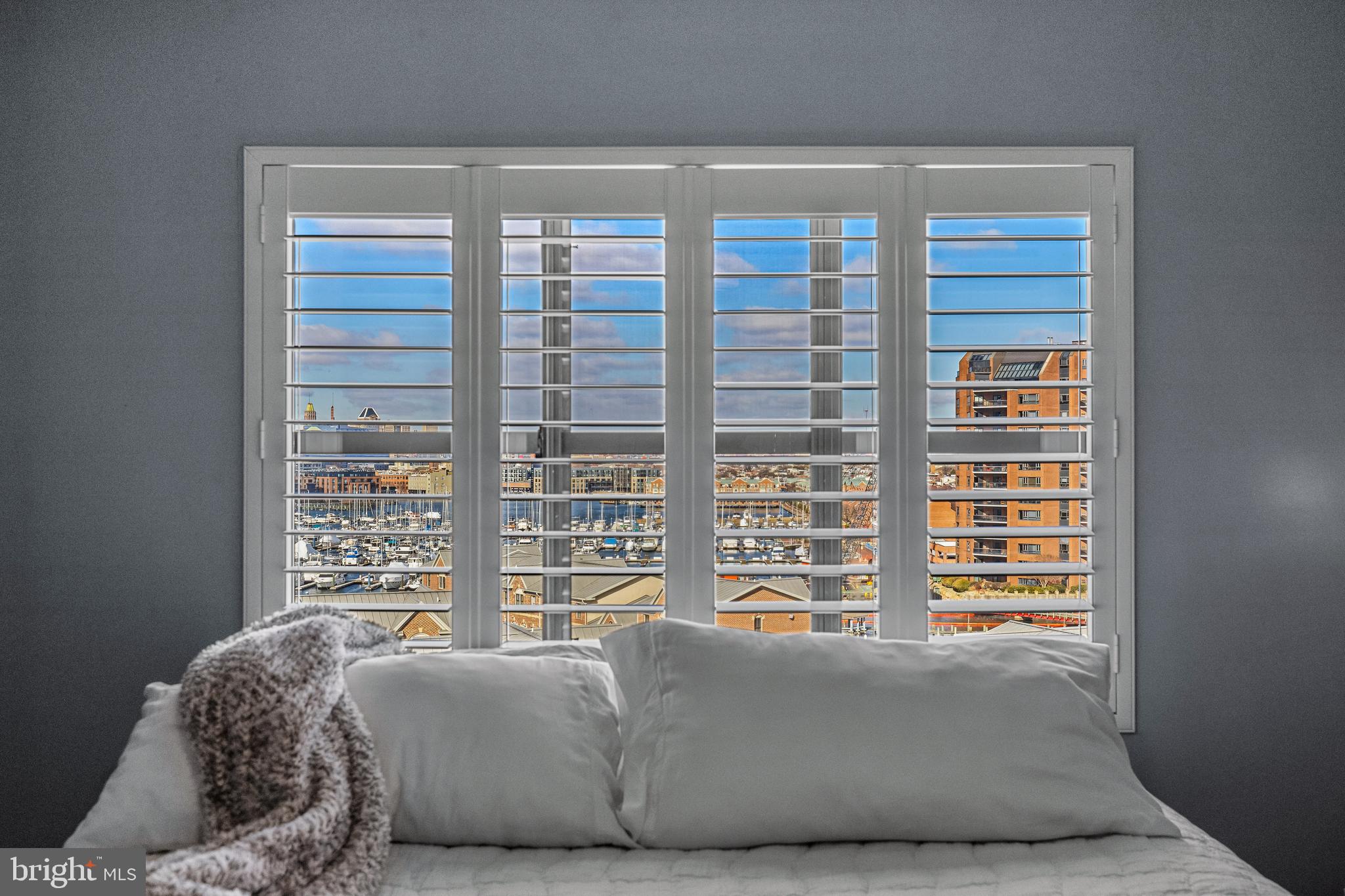 2702 Lighthouse Point East, Unit 720 Baltimore, MD 21224 - Photo 17 of 37 a living room with couch and a window