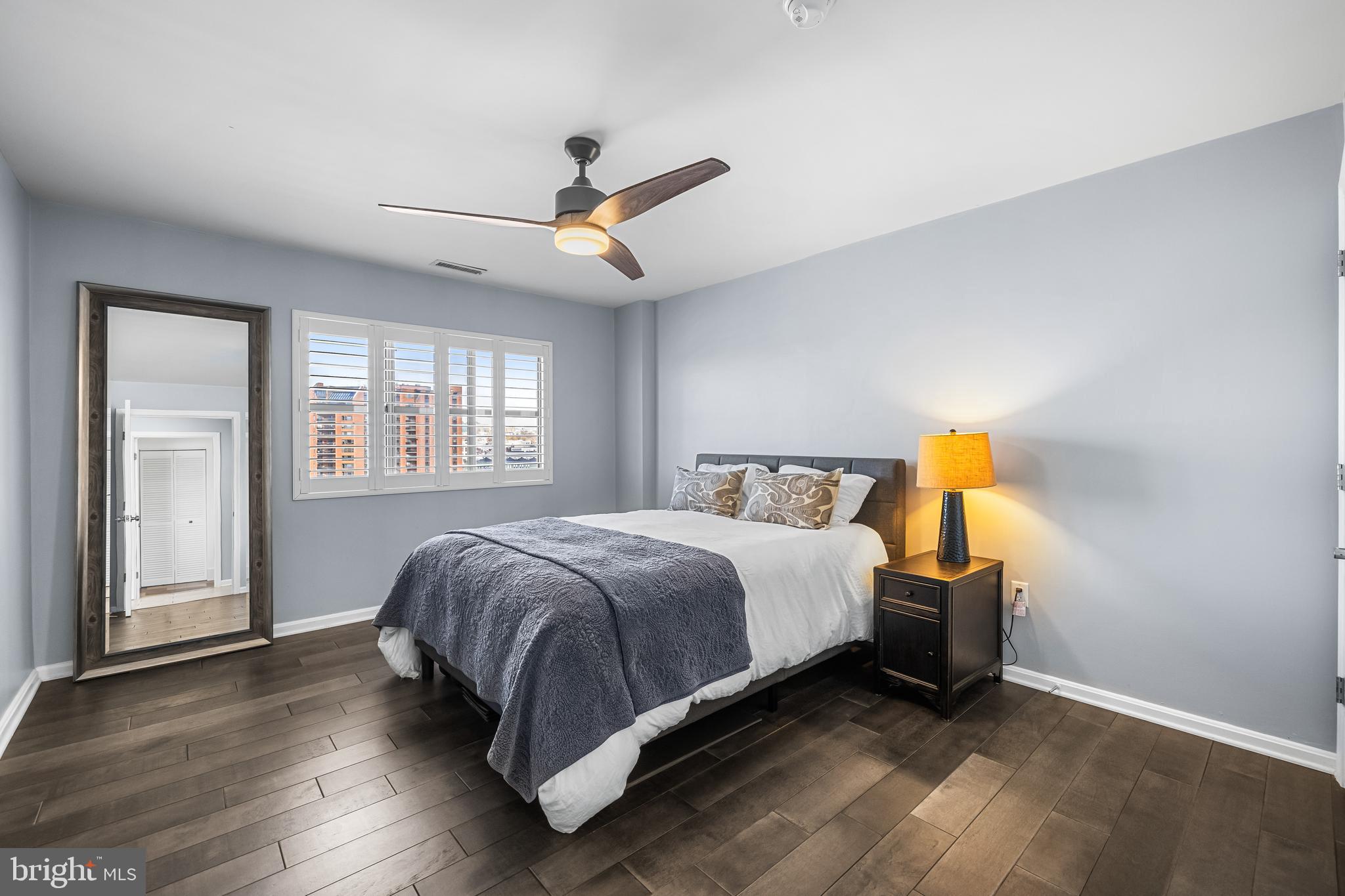 2702 Lighthouse Point East, Unit 720 Baltimore, MD 21224 - Photo 20 of 37 a bedroom with a bed and a window