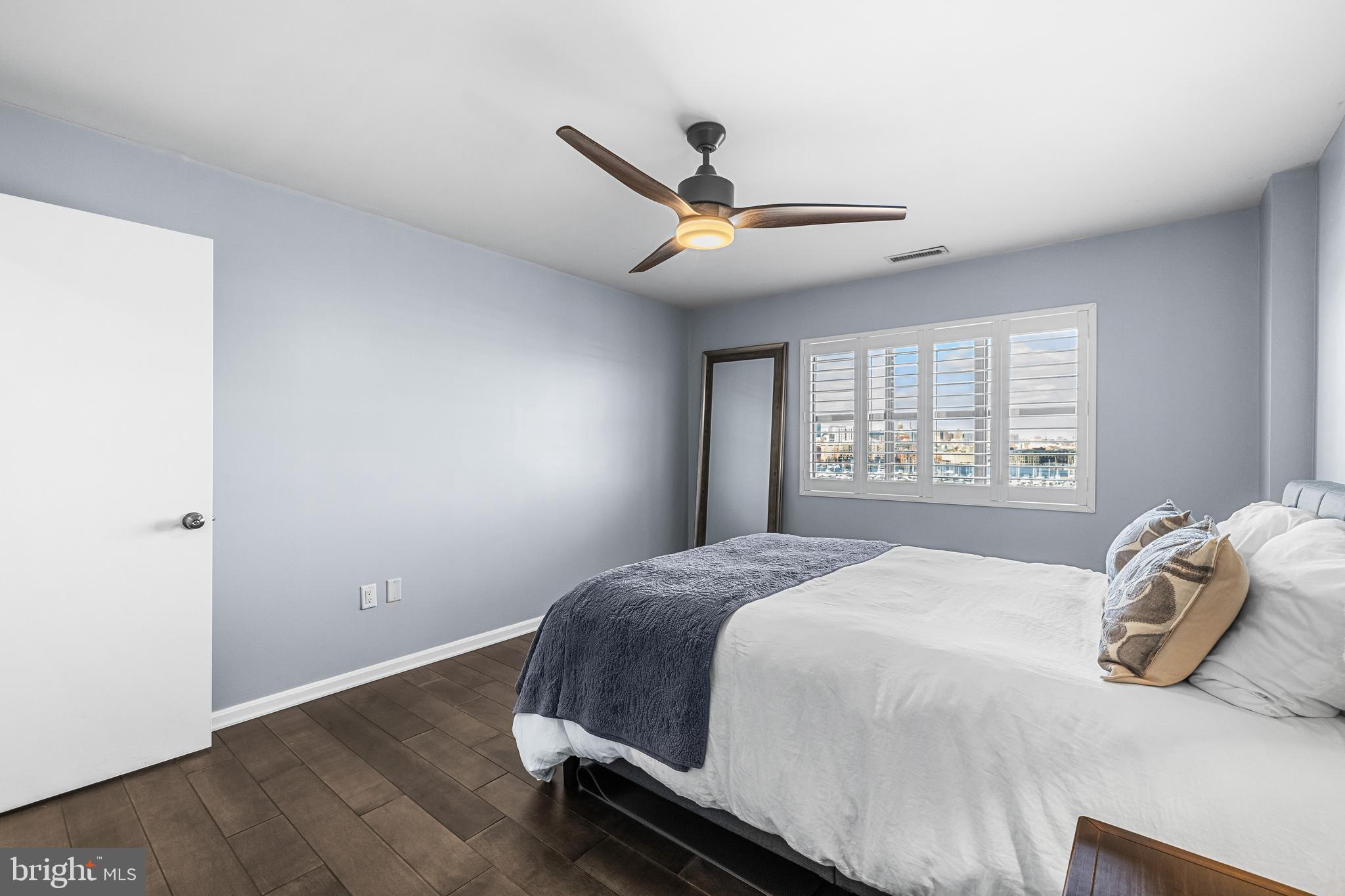 2702 Lighthouse Point East, Unit 720 Baltimore, MD 21224 - Photo 21 of 37 a bedroom with a bed and window