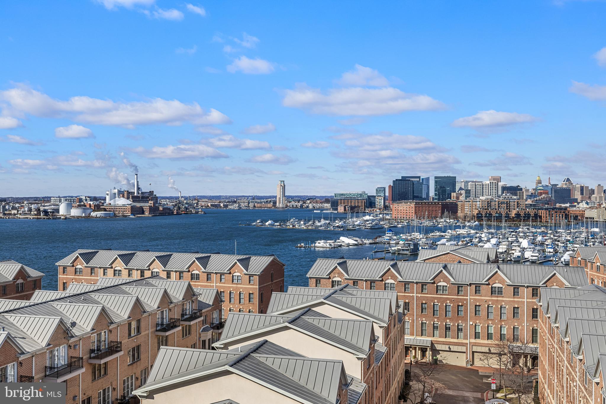 2702 Lighthouse Point East, Unit 720 Baltimore, MD 21224 - Photo 3 of 37 a view of a roof deck with two couches and wooden floor