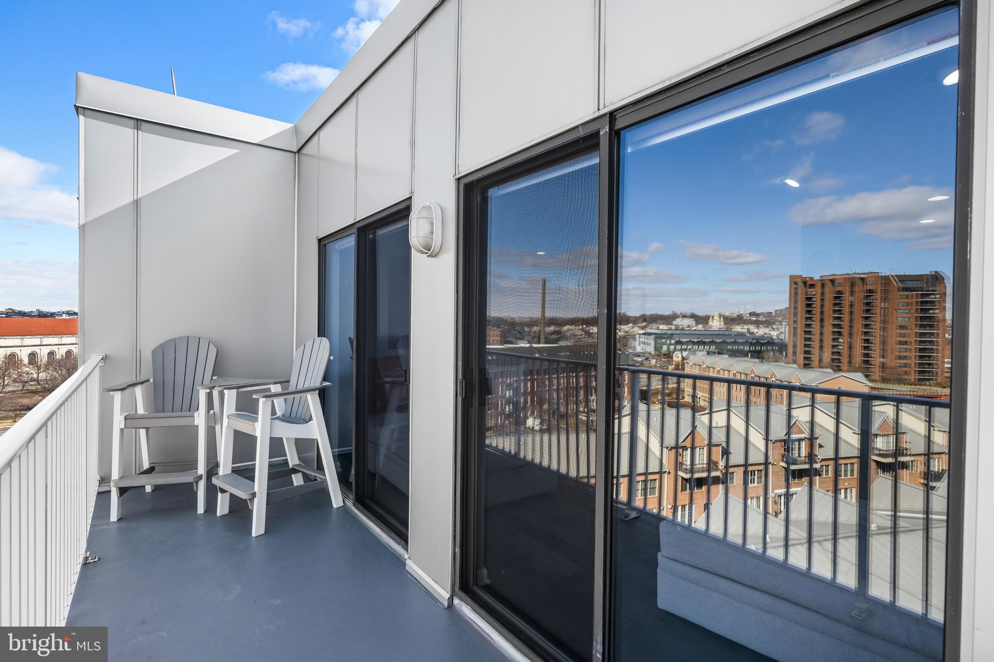 2702 Lighthouse Point East, Unit 720 Baltimore, MD 21224 - Photo 31 of 37 a view of a balcony with chairs