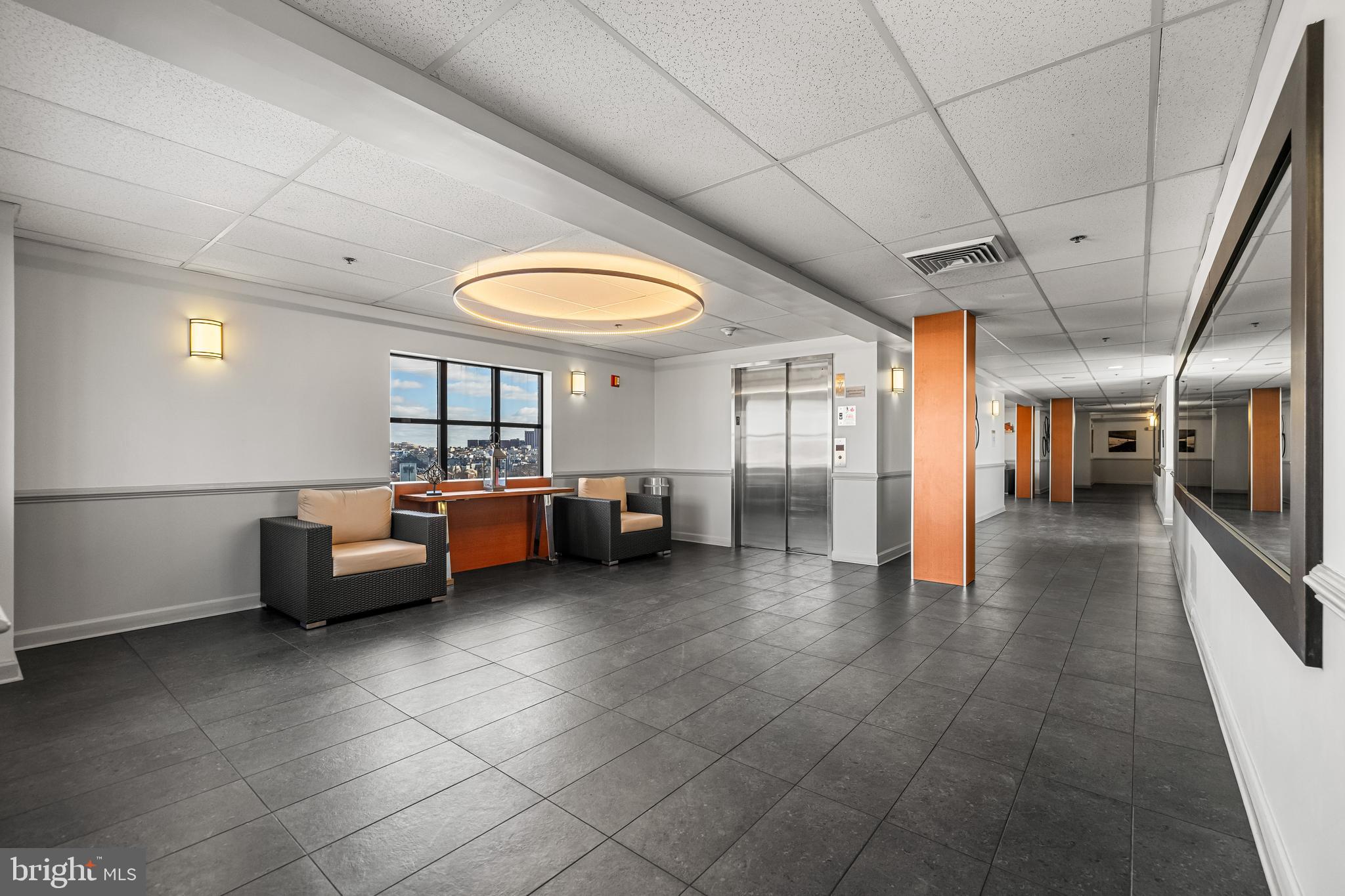 2702 Lighthouse Point East, Unit 720 Baltimore, MD 21224 - Photo 34 of 37 a bedroom with furniture and a large window