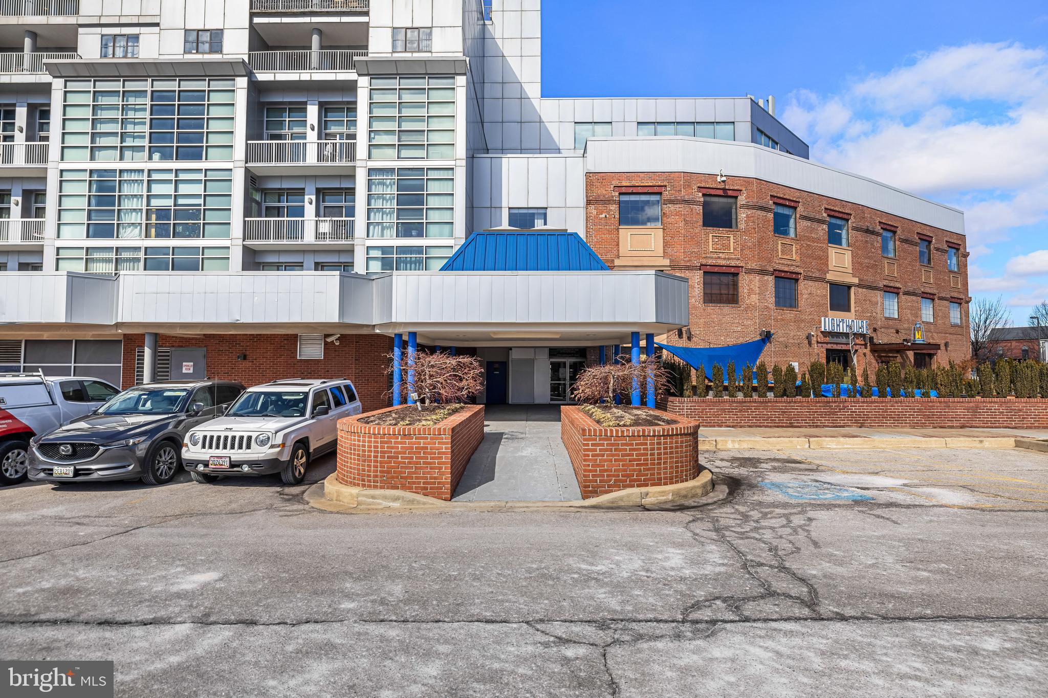 2702 Lighthouse Point East, Unit 720 Baltimore, MD 21224 - Photo 37 of 37 a front view of a building with cars parked
