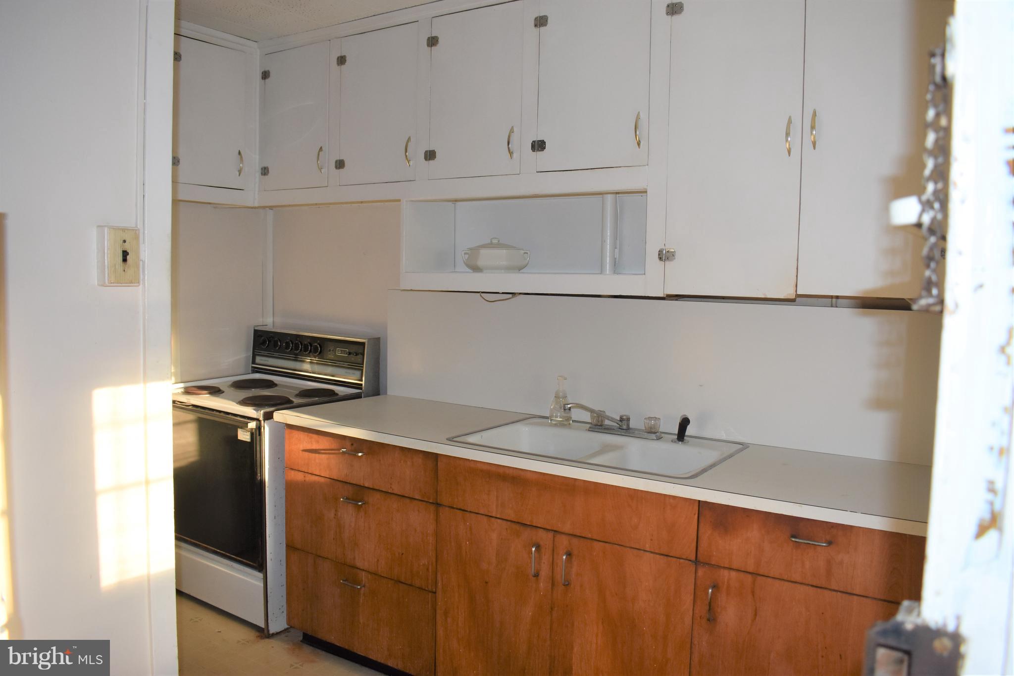 1205 3rd Road Baltimore, MD 21220 - Photo 7 of 12 a kitchen with stainless steel appliances granite countertop a sink and a stove