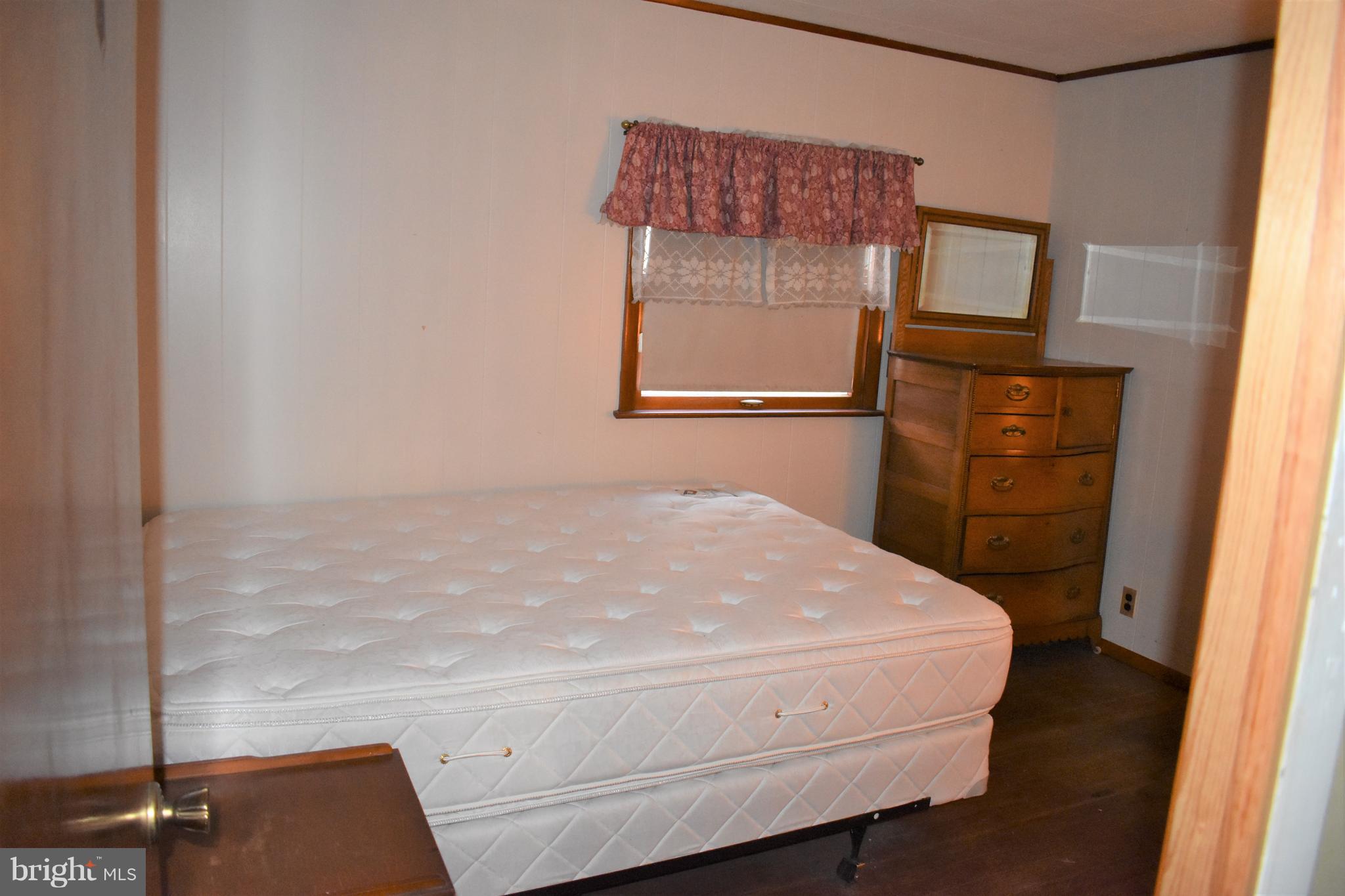 1205 3rd Road Baltimore, MD 21220 - Photo 9 of 12 a room with a bed and wooden floor