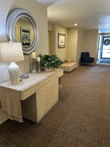 a living room with furniture and a mirror