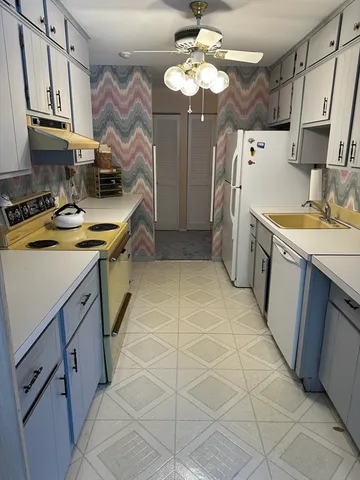 a kitchen with stainless steel appliances a sink stove and cabinets