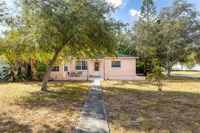 a view of a yard with a house and a tree