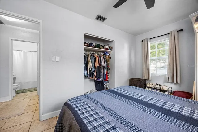 a bedroom with a bed and a window