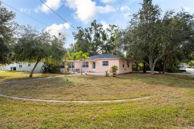 a front view of a house with a yard and trees