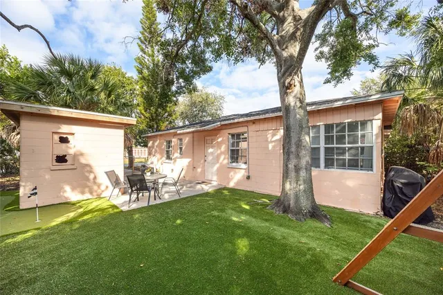 a view of backyard with a patio and a garden