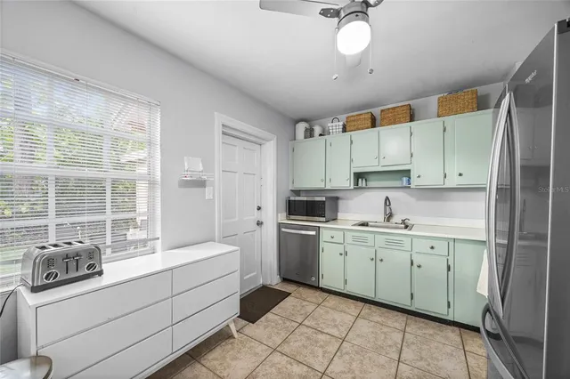 a kitchen with a sink cabinets and window