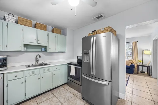 a kitchen with stainless steel appliances a refrigerator sink and cabinets