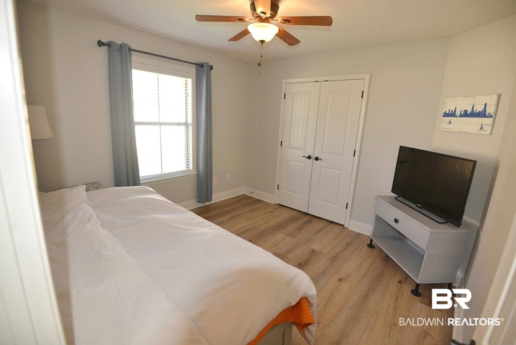 11201 Herschel Loop Daphne, AL 36526 - Photo 19 of 32 Bedroom featuring a closet, light hardwood / wood-style floors, and ceiling fan