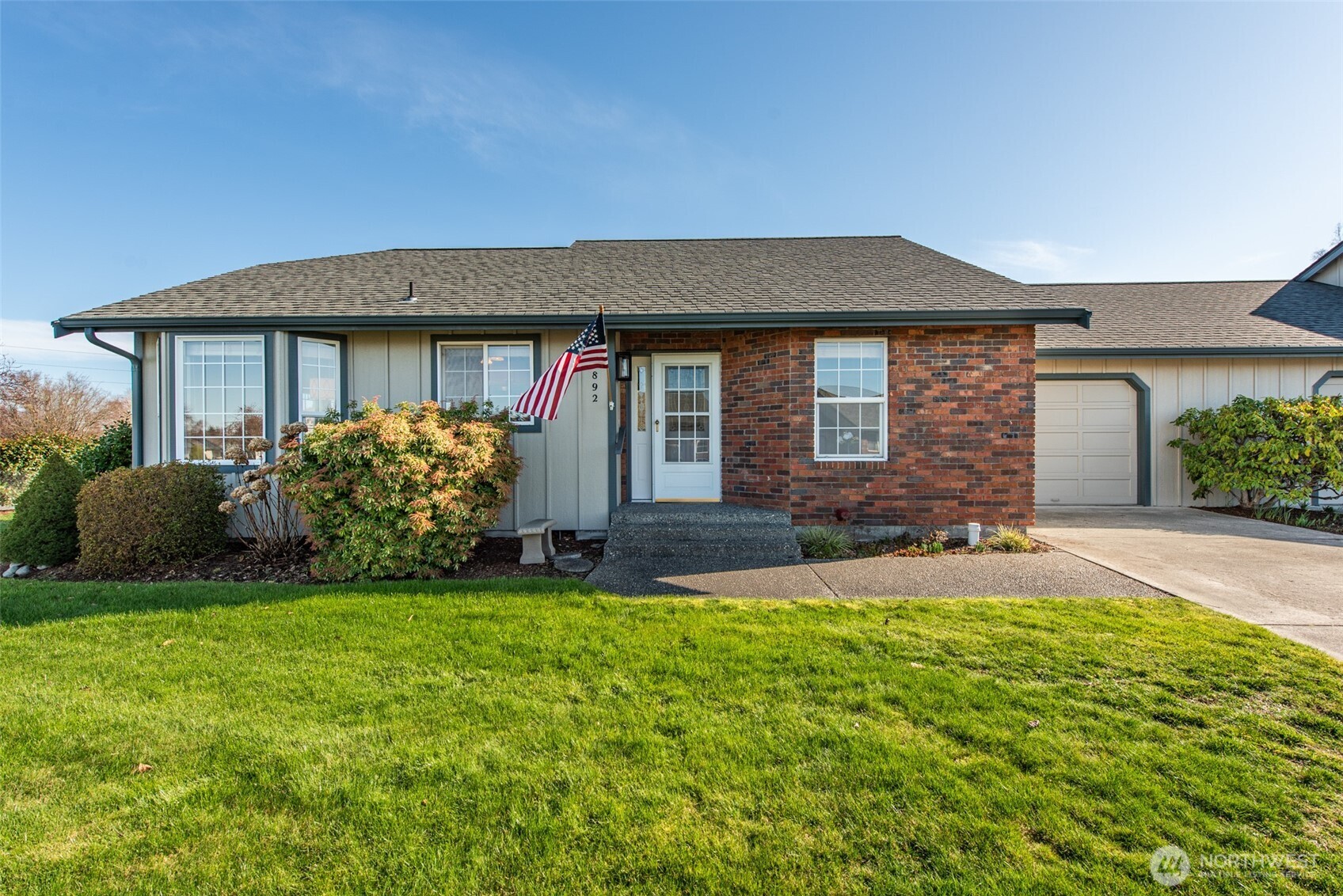 892 North Oxford Way Sequim, WA 98382 - Photo 1 of 38 a front view of a house with a yard and garage