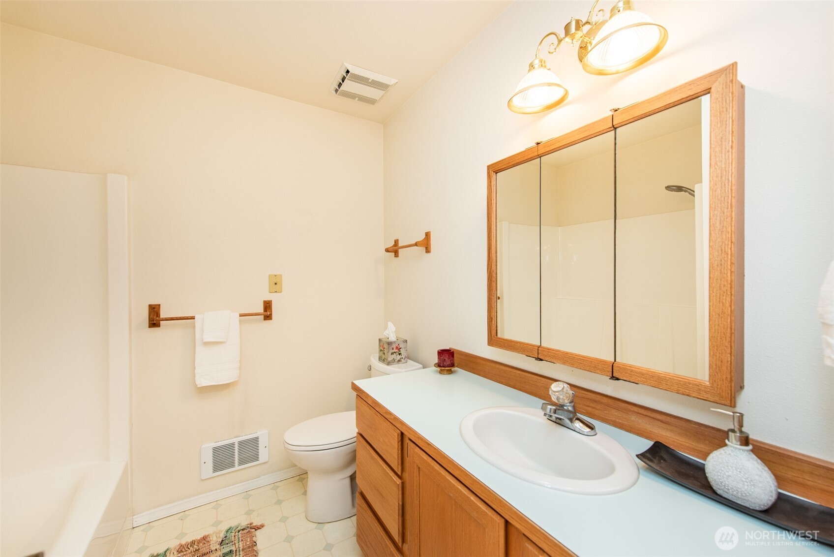 892 North Oxford Way Sequim, WA 98382 - Photo 23 of 38 a bathroom with a sink a toilet and a mirror