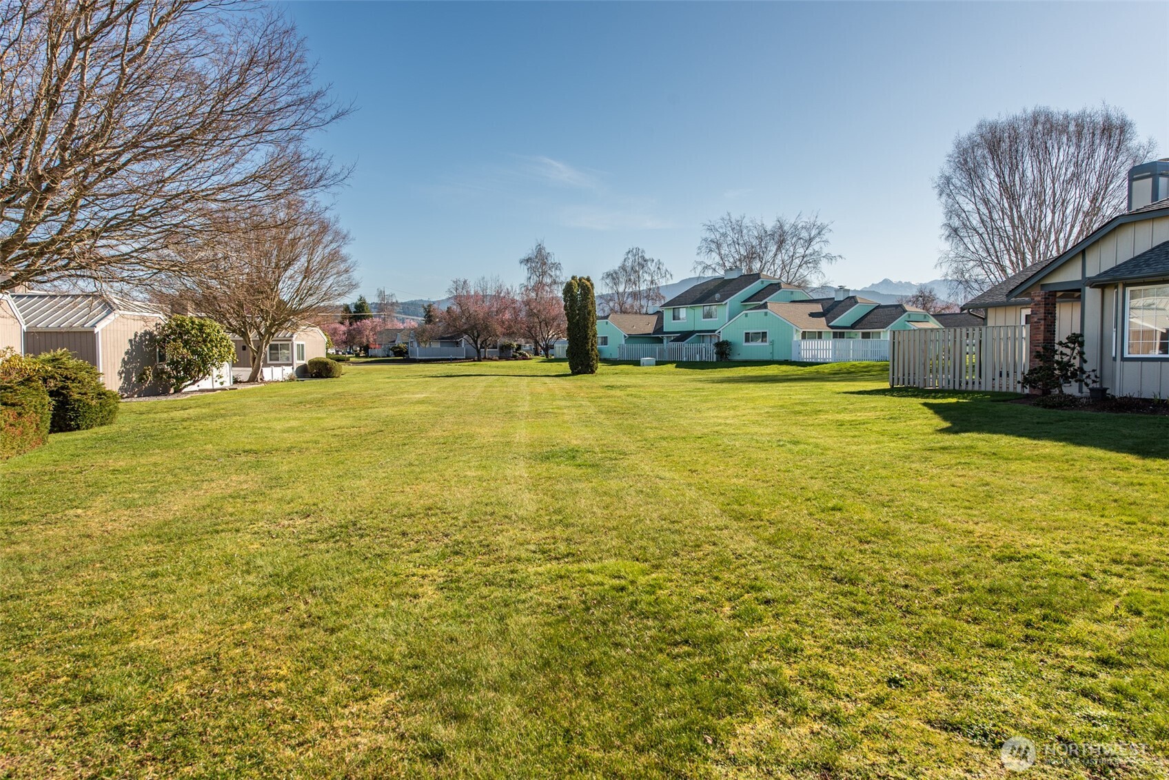 892 North Oxford Way Sequim, WA 98382 - Photo 28 of 38 a view of a large pool with lawn chairs under an umbrella
