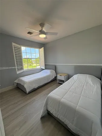 a bedroom with two beds and a chandelier