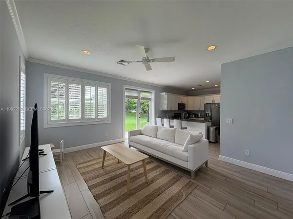 a living room with furniture and a large window