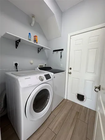 a view of storage and utility room with washer and dryer