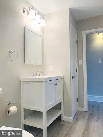 a bathroom with a sink vanity and mirror