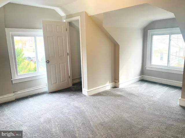 a front view of house with yard and trees around