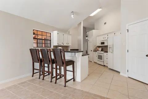 a kitchen with stainless steel appliances a refrigerator and cabinets