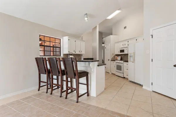 a kitchen with stainless steel appliances a refrigerator and cabinets