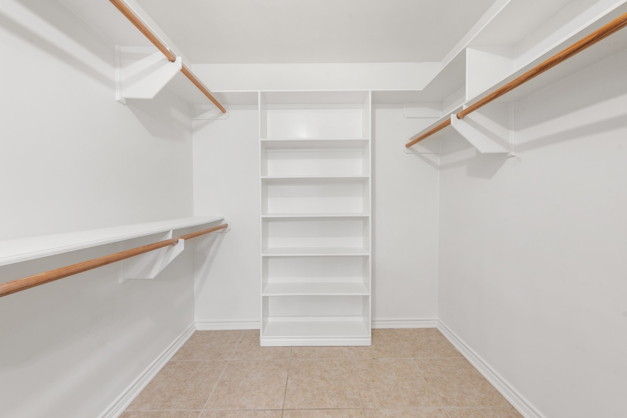 4505 Kensington Road Bryan, TX 77802 - Photo 18 of 26 En suite primary large walk in closet with built in shelving unit.