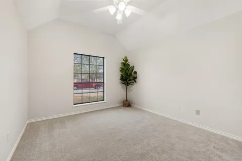 an empty room with windows and flower pot