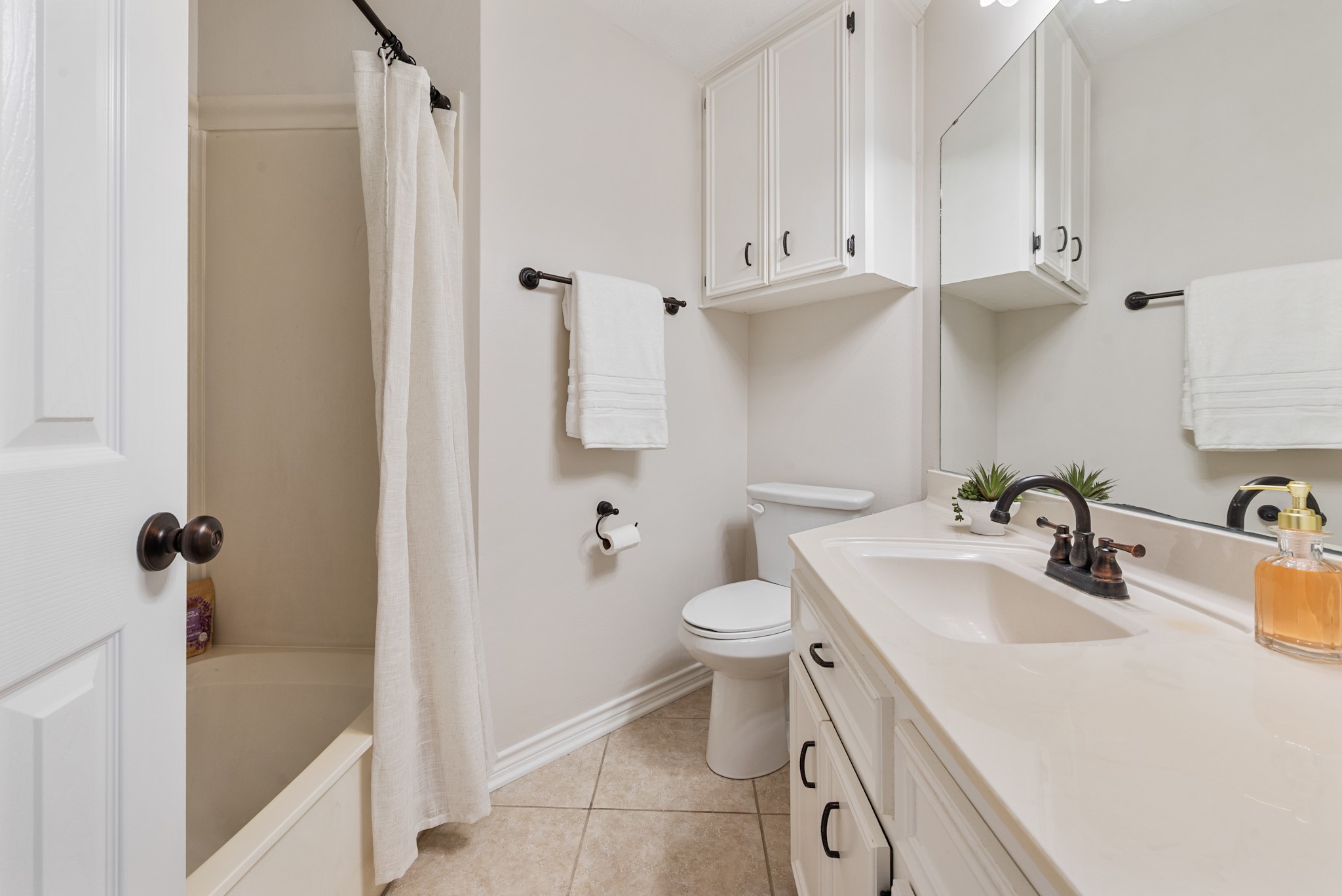 4505 Kensington Road Bryan, TX 77802 - Photo 21 of 26 Hall bathroom features tub/shower and plenty of storage with large counter top with sink and storage underneath as well as storage cabinet above toilet area.