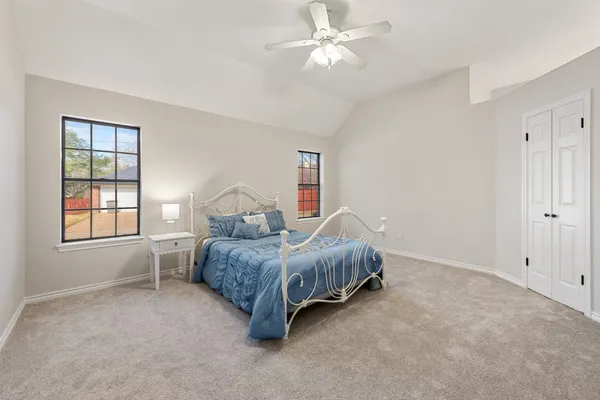 a spacious bedroom with a bed and a window