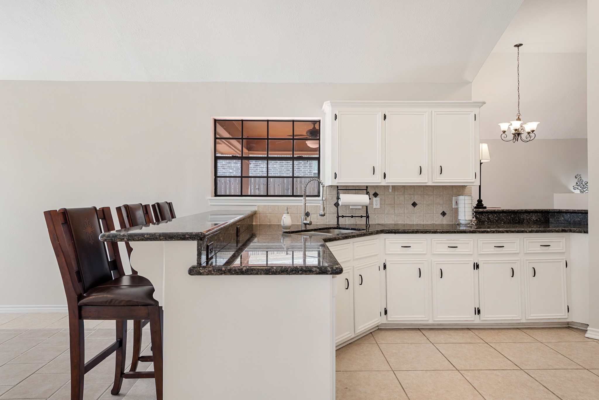 4505 Kensington Road Bryan, TX 77802 - Photo 10 of 26 Painted cabinets, eat at bar and window to the back patio