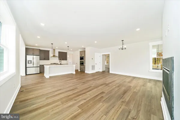 a view of kitchen with wooden floor and electronic appliances