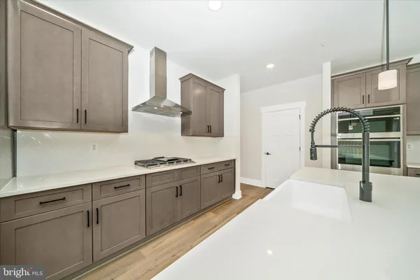 a view of open kitchen with wooden floor and a kitchen space