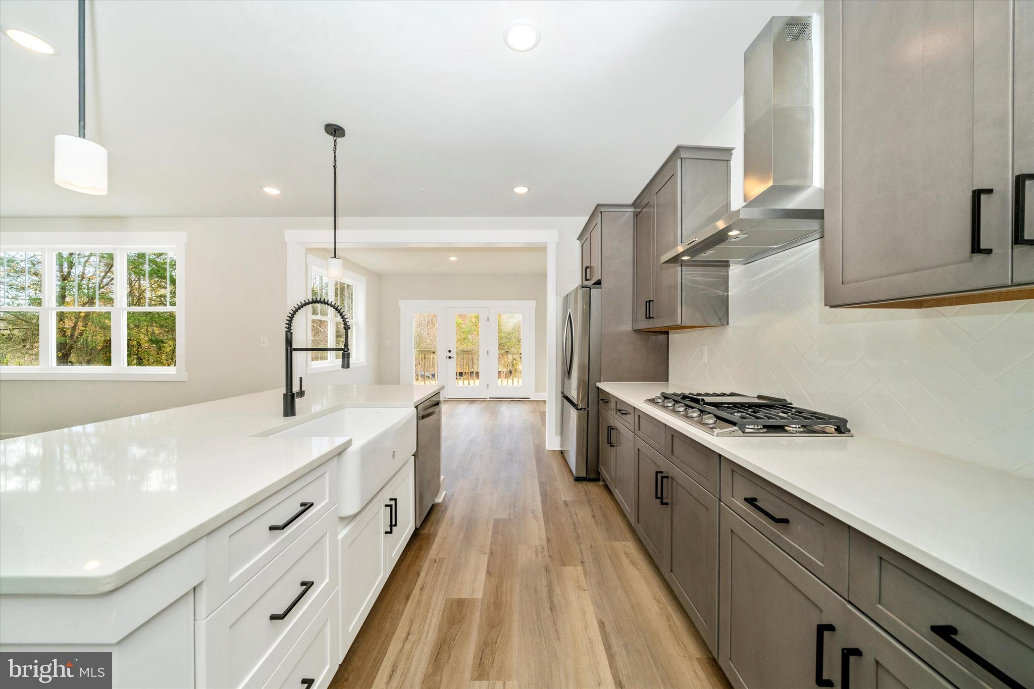 1154 Mt Zion Marlboro Road Lothian, MD 20711 - Photo 22 of 66 a kitchen with stainless steel appliances granite countertop a stove a sink and a wooden floor