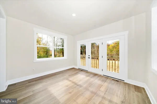 a spacious bedroom with a bed a chandelier and a window
