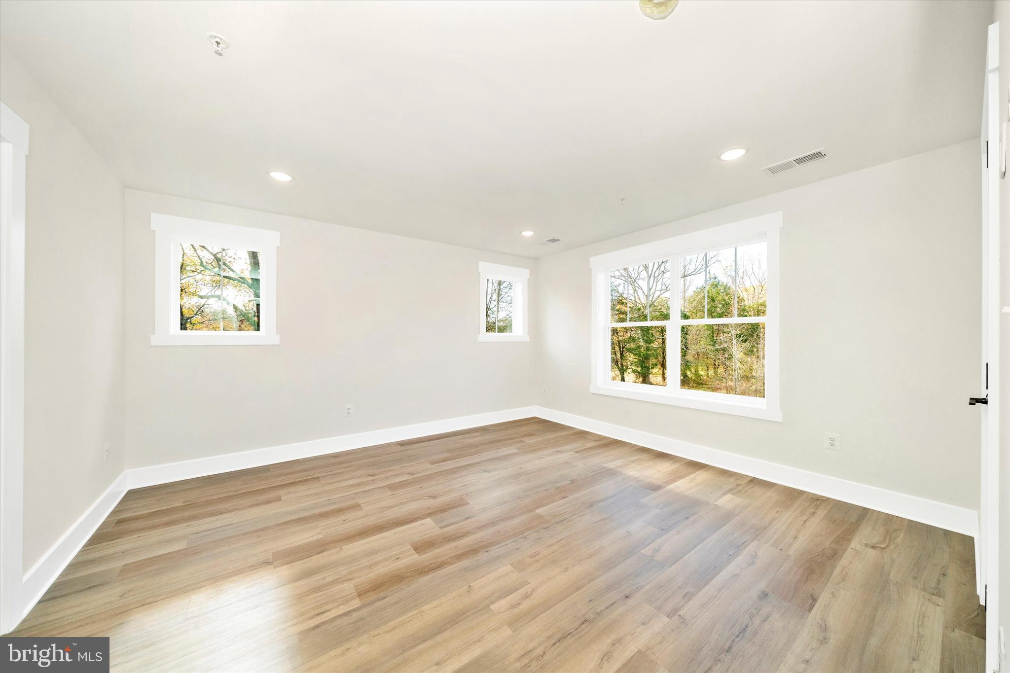 1154 Mt Zion Marlboro Road Lothian, MD 20711 - Photo 30 of 66 an empty room with wooden floor and windows