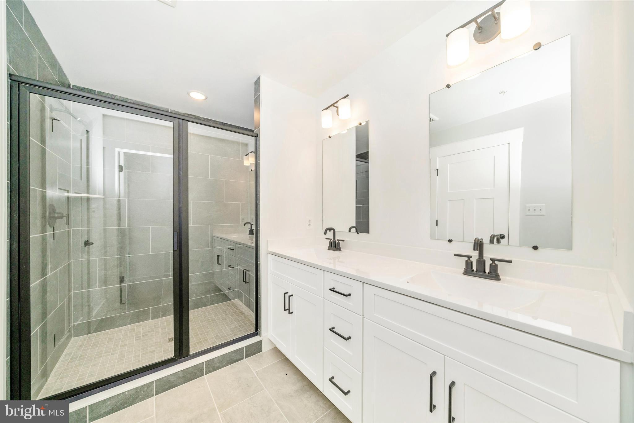 1154 Mt Zion Marlboro Road Lothian, MD 20711 - Photo 33 of 66 a bathroom with a double vanity sink mirror and shower