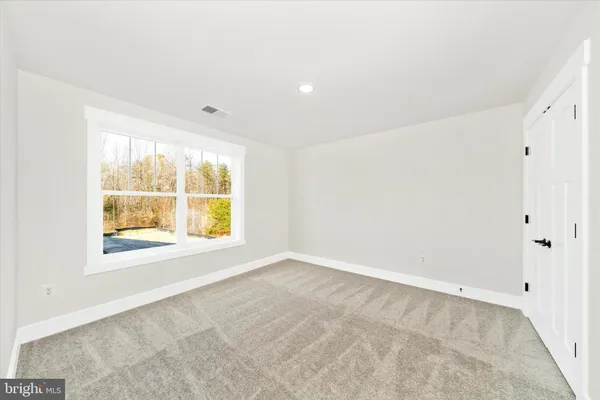 a bathroom with a sink a toilet and a large mirror