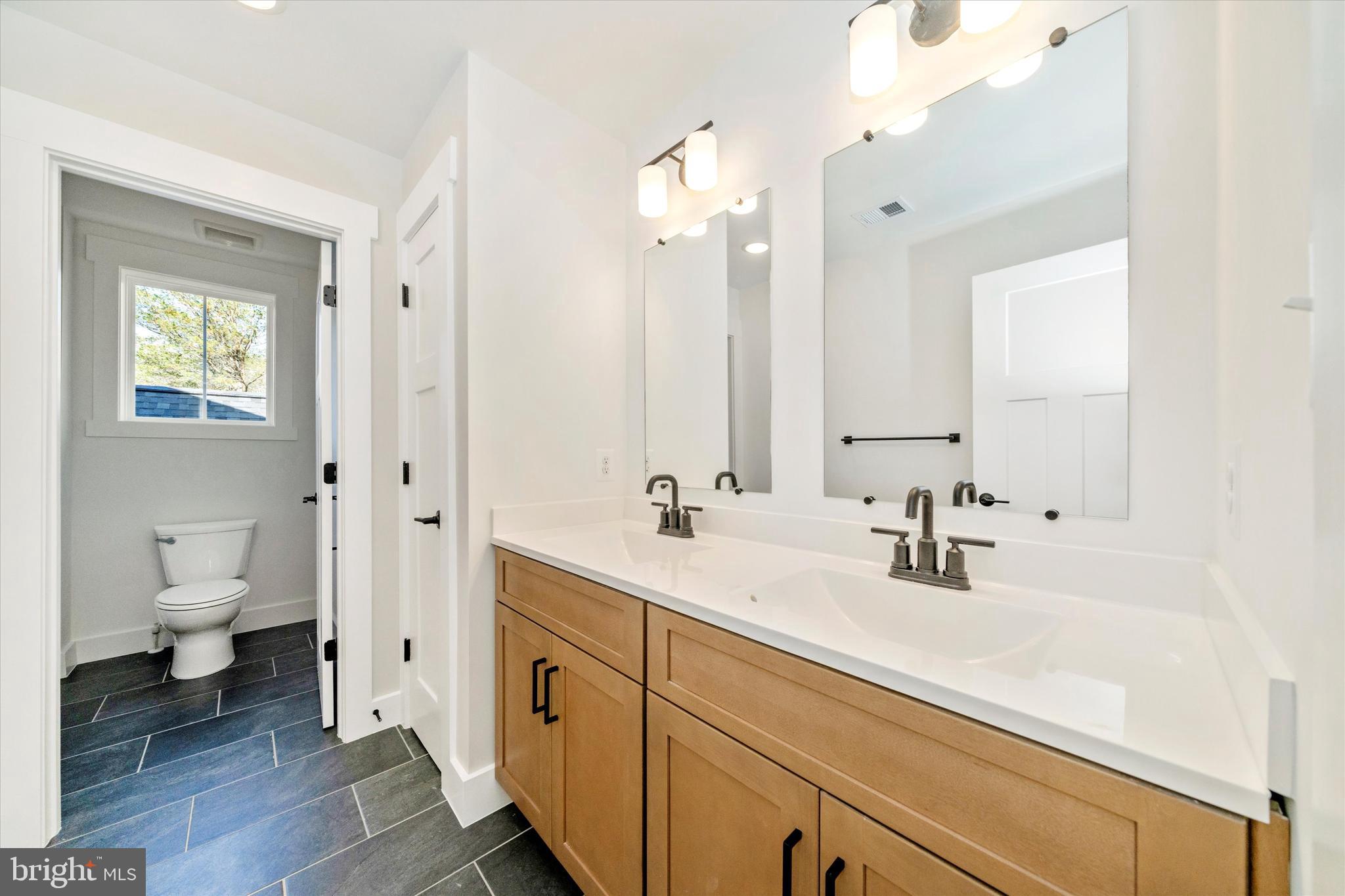 1154 Mt Zion Marlboro Road Lothian, MD 20711 - Photo 40 of 66 a bathroom with a sink a toilet and a large mirror